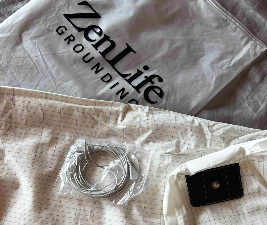 Earthing sheet with plug-in cord and bag labeled 'ZenLife Grounding.'